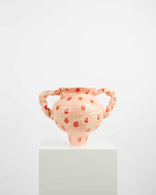 The pink vase with red polka dots